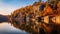 Vibrant Fall Reflection: Stone House By The Lake