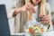 The vibrant flavors of healthy eating at the workplace as a woman indulges in a refreshing salad. With a bowl filled with crisp