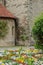 Vibrant flower bed of adorns the exterior of a stonewall building with a vibrant red tiled roof