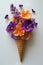 Vibrant flowers arranged in an ice cream cone against a white background