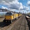 Vibrant freight trains on railway station, goods transported on colorful wagons