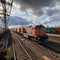 Vibrant freight trains on railway station, goods transported on colorful wagons