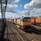 Vibrant freight trains on railway station, goods transported on colorful wagons