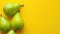 Vibrant Fresh Green Pears on Bright Yellow Background