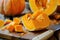 Vibrant Fresh Pumpkin Chunks on a Rustic Wooden Cutting Board with a Sharp Knife