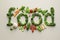 Vibrant Fresh Vegetables Arranged to Spell 'Food' on a Neutral Background