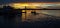 Vibrant Golden colored dramatic cloudy Marina/dock Sunset