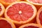 Vibrant grapefruit indulgence, close-up of sliced grapefruits