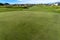 Vibrant green grasses on the fairway of a golf course viewed on a sunny day