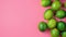 Vibrant Green Limes on Bright Pink Background