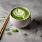 A vibrant green matcha latte in a ceramic cup with a bamboo whisk beside it1