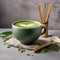 A vibrant green matcha latte in a ceramic cup with a bamboo whisk beside it2