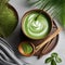A vibrant green matcha latte in a ceramic cup with a bamboo whisk beside it3