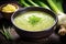 A vibrant green soup with herbs, surrounded by fresh ingredients