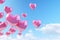 Vibrant Heart Balloons Floating Against a Blue