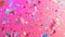 Vibrant holographic confetti falling on a bold pink background, generative ai