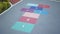 Vibrant hopscotch game painted on urban asphalt surface