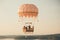 A vibrant hot air balloon gently floats above a picturesque lake surrounded by serene natural beauty., Whimsical wedding in a hot