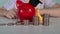 This vibrant image depicts a childs hands cradling a red piggy bank adorned with a graduation cap