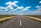 Vibrant image of highway and blue cloudy sky