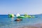 Vibrant inflatable playground with slides near the coastline on sunny summer day.