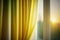 Vibrant lemon ombre curtains adorn bedroom windows.