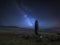 Vibrant Milky Way composite image over landscape of Ancient prehistoric stones in Wales