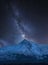Vibrant Milky Way composite image over landscape of Mount Snowdon and other peaks in Snowdonia National Park