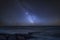 Vibrant Milky Way composite image over landscape of pier at sea