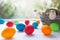 Vibrant multicolored Easter eggs on a white background with wicker basket with white flowers