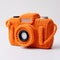 Vibrant Orange Knitted Camera In Minimalist Still Life Photography