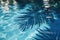 Vibrant palm leaf shadows play on the surface of a tranquil, sunlit swimming pool with blue water. Vacation, holiday