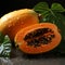 Vibrant Papaya Fruit With Two Leaves On Dark Surface