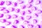 Vibrant and Pastel Purple Heart Shaped Marshmallow Candies Scattered on White Background