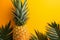 Vibrant pineapple, palm leaves on orange yellow backdrop