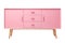 Vibrant, pink, modern sideboard with sleek handles and splayed wooden legs, a bold statement piece for playful interiors