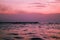 Vibrant pink and purple-hued sunset sky at the Thalankuppam Pier in Chennai, India.