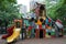 A vibrant playground featuring a slide and a nearby building amidst a sea of bright colors, A playground made entirely from