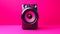 Vibrant Portraiture Of A Large Sound Speaker On A Pink Background