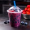 Vibrant purple slushie in a clear plastic cup with fresh berry garnish