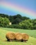 Vibrant Rainbow over Three Rolled Haystacks