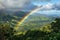 A vibrant rainbow stretches across the sky, creating an arch over a fertile valley with rich green vegetation, A rainbow spanning