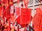 Vibrant red Chinese wishing cards hanging on a rack a