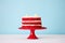 a vibrant red velvet cake on a stand