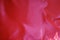 Vibrant reddish pink satin polyester fabric