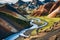 Vibrant rhyolite mountains and winding river in Iceland. Landmannalaugar Multicolored Rhyolite Peaks