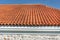 Vibrant Roof Design: Red Corrugated Tiles Enhancing Modern House Aesthetics