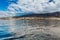 Vibrant scenery and deep-blue waters of the Tenerife west coastline as seen from a yacht. The dormant Teide volcano can be seen in