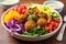 a vibrant shot of a falafel salad with rainbow-colored toppings