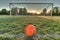 Vibrant soccer ball centered in front of soccer goal at sunrise